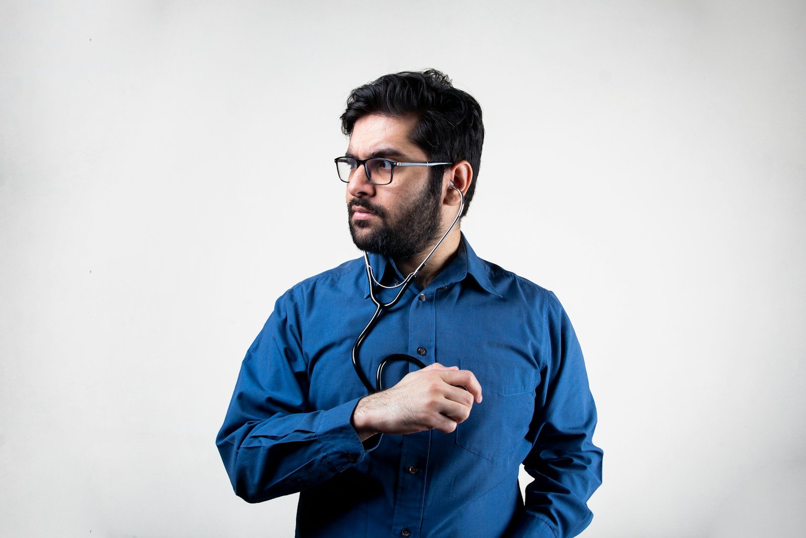 man in blue dress shirt wearing black framed eyeglasses
